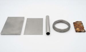 Titanium plate, titanium sheet, titanium tubing, titanium wire alongside rusted carbon steel, to answer does titanium rust